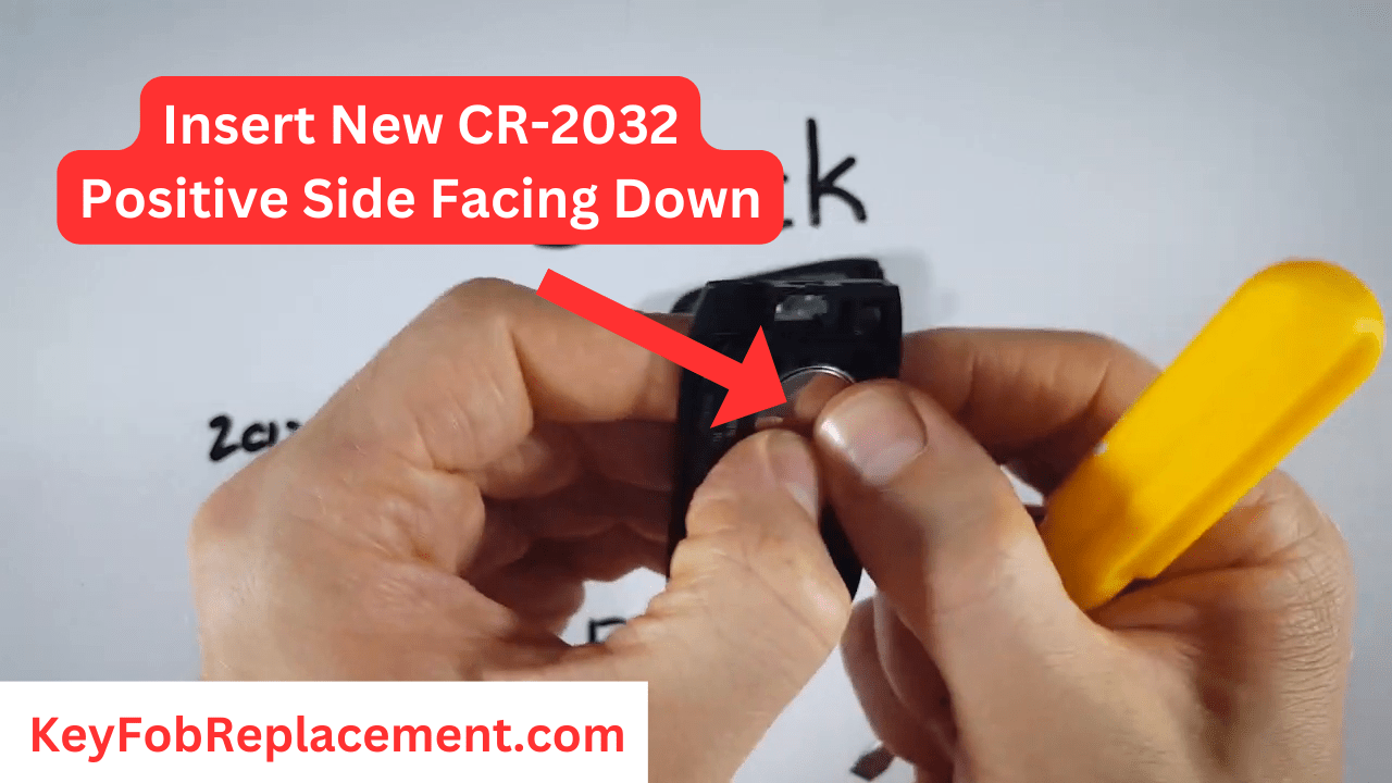 Buick Encore Install new CR2032 battery (-) down, click in place