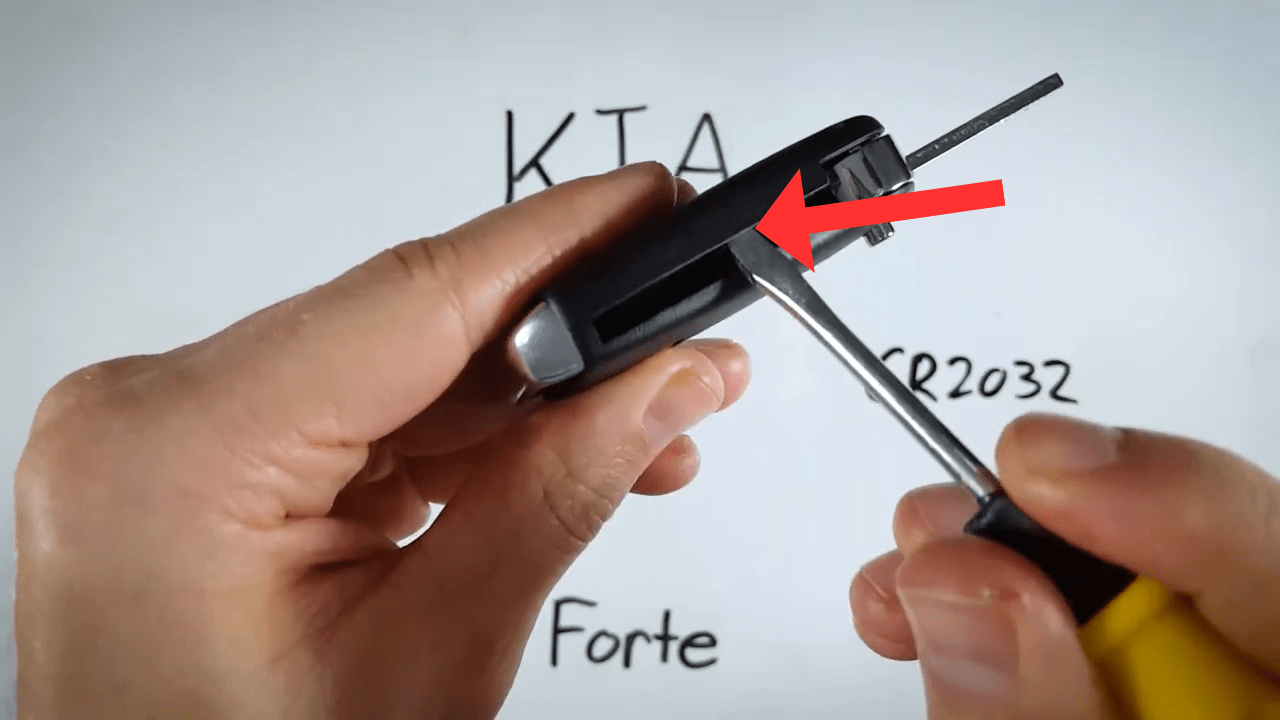 Kia Forte Insert screwdriver, pry till snap, pull off cover